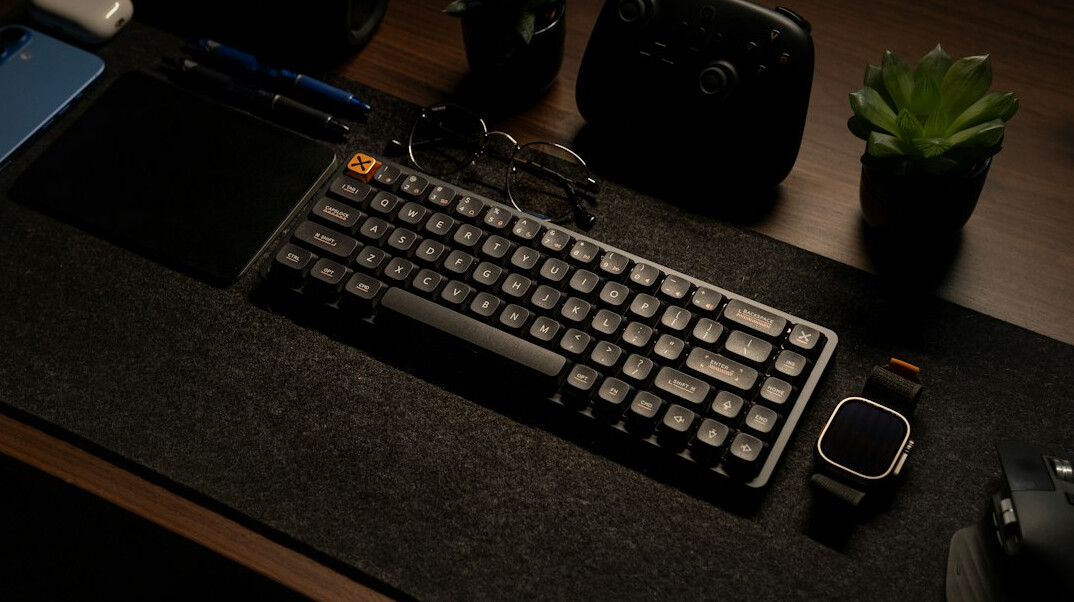 Vintage typewriter on a wooden desk with notebook and coffee